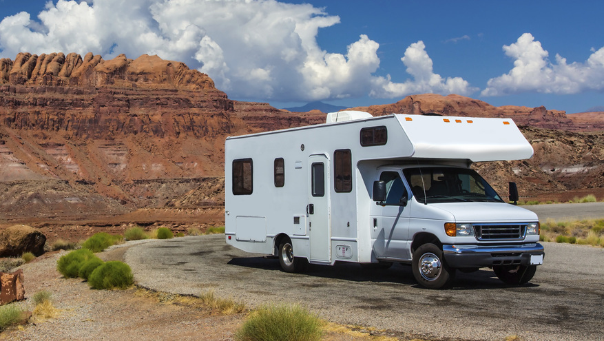 Recreational Vehicle Loan - RV parked on the road with red rock cliffs in the background.