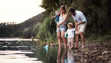 A family of four fish and play in a lake