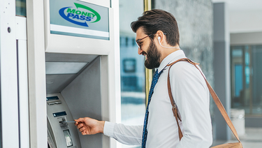 A businessman uses a MoneyPass ATM 