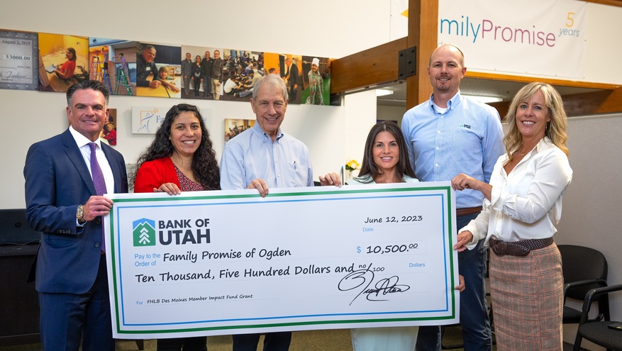 Bank of Utah representatives deliver a $10,500 check to the Family Promise organization