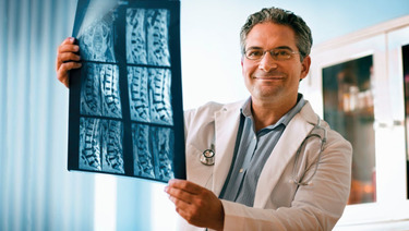 Health Savings - Doctor holding x-ray.