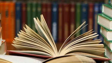 Mortgage Terms - Stacks of books on library table.