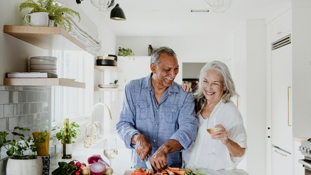 senior couple cooking dinner together