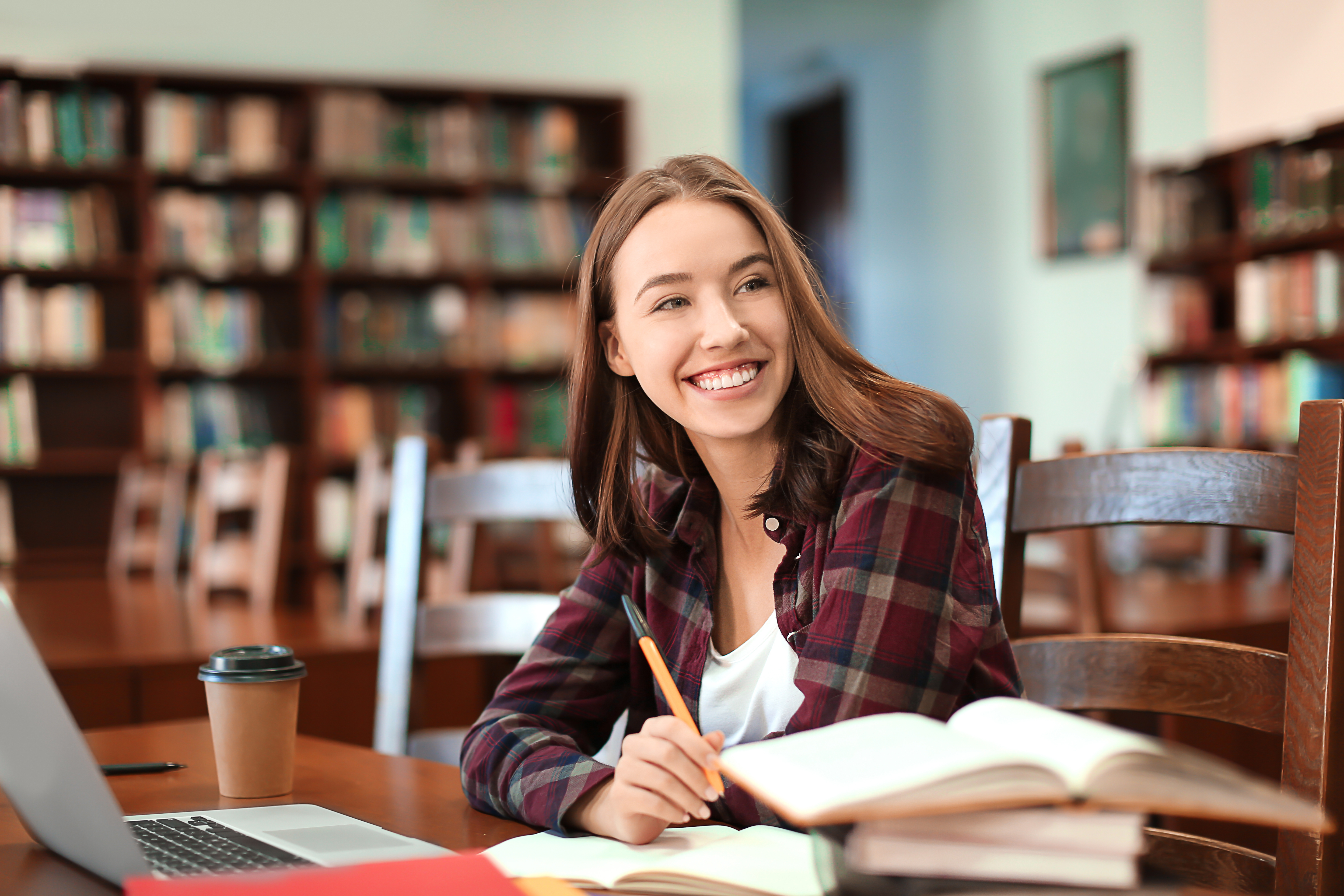 Student studying at a library table