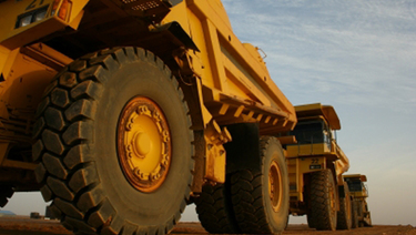 Convoy of large dump trucks.