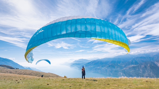 A skier speeds down a mountain trail