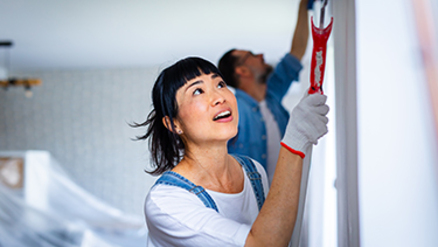 middle aged couple in front of home