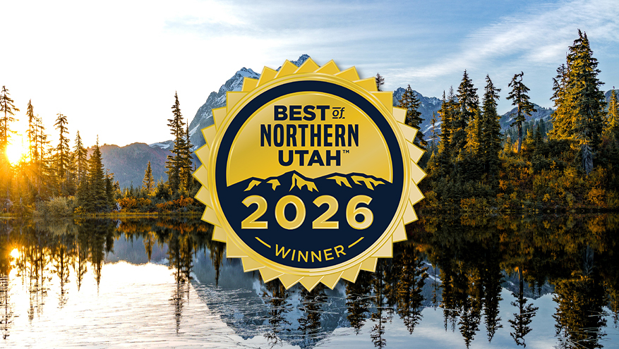 A panoramic mountain landscape with a lake reflecting pine trees and a bright sunrise, featuring a gold seal that reads "Best of Northern Utah 2026 Winner".