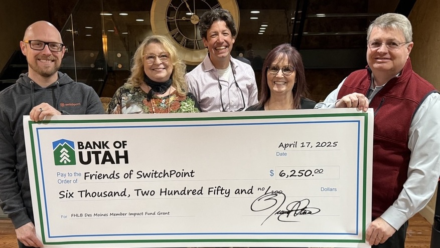 Representatives of Friends of Switchpoint and Bank of Utah pose together while holding a ceremonial check from Bank of Utah.