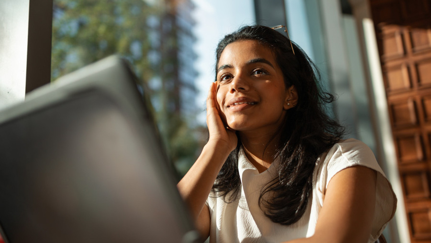 young woman smiling using her laptop