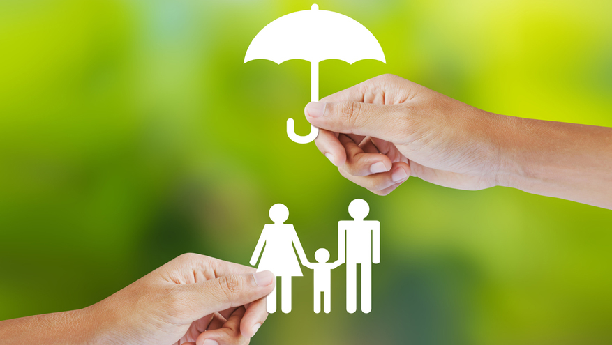Paper cut out doll family under paper umbrella, being held up by human hands.
