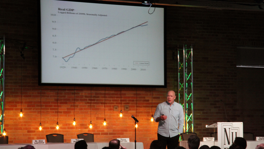 Peter Rupert speaking in front of crowd giving his presentation at the Bank of Utah 2017 economic outlook event.
