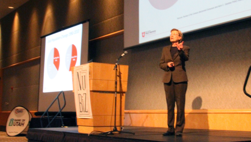 Dr. Pam Perlich presenting in front of crowd at Bank of Utah 2018 economic outlook.