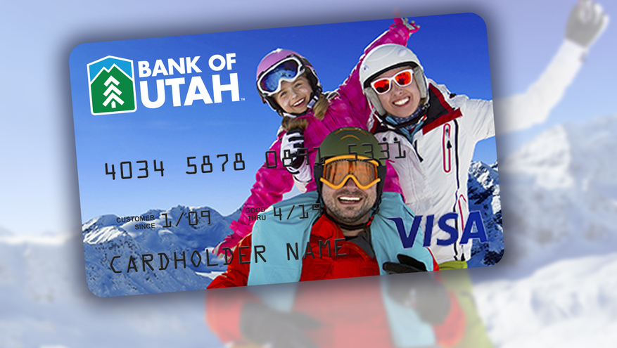 Image of family looking at camera in ski clothes on top of a mountain, captured on a personalized debit card