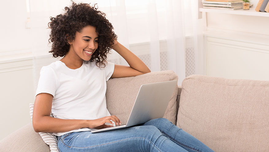 Smiling young woman using a laptop