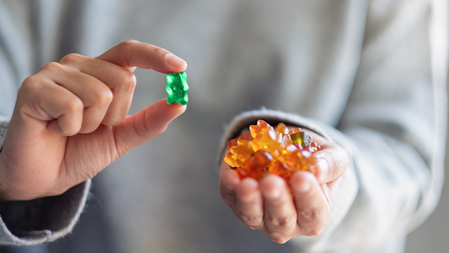 Closeup of a man holding gummy bears in his hands