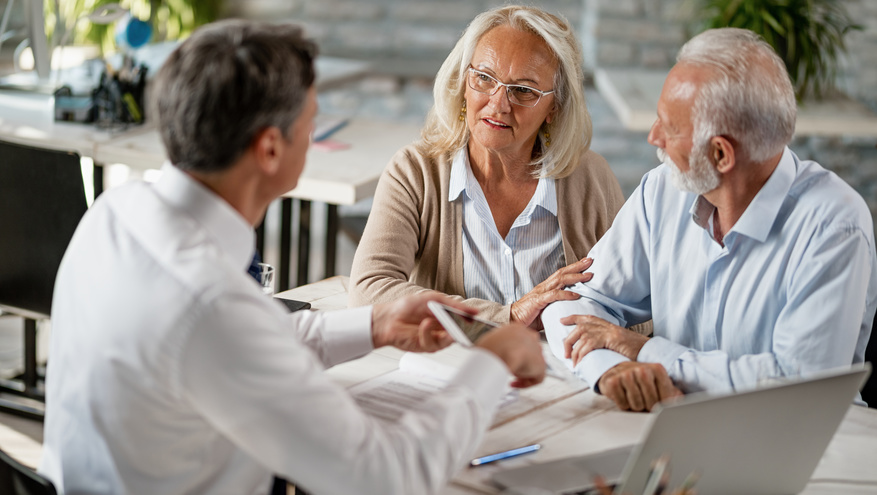 Photo of a senior couple meeting with a financial professional