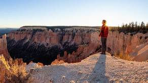 a hiker looks out across Bryce Canyon